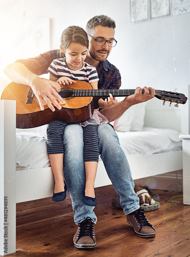 Teaching her how to play the guitar