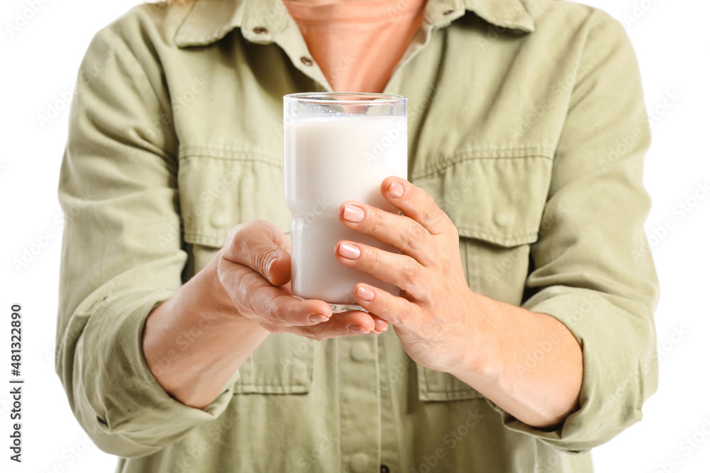 Mature woman with glass of milk on white background, closeup