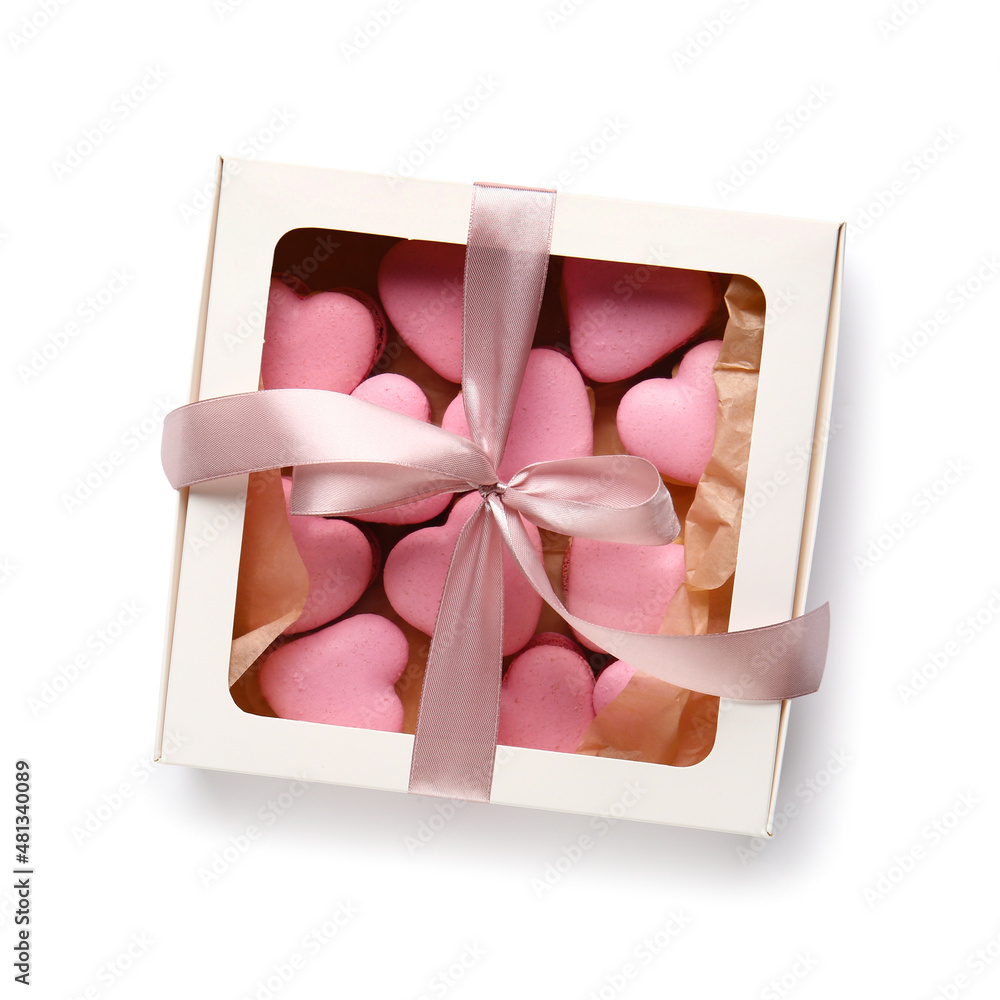 Box with tasty heart-shaped macaroons on white background