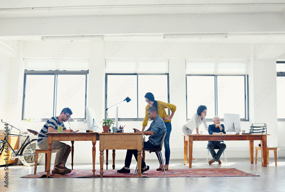 Its a creative environment. Shot of a group of creative professionals working in an office.