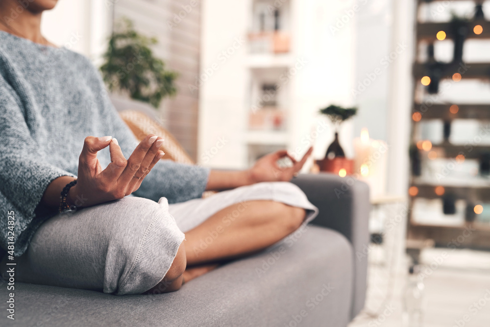 I could sit here all day. Cropped shot of an unrecognizable woman sitting in a lotus position alone 