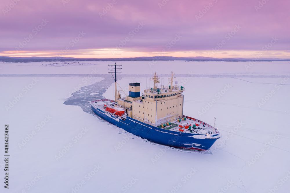 Icebreaking vessel in Arctic with background of sunset