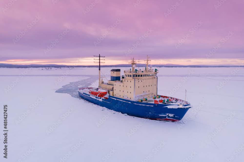 Icebreaking vessel in Arctic with background of sunset