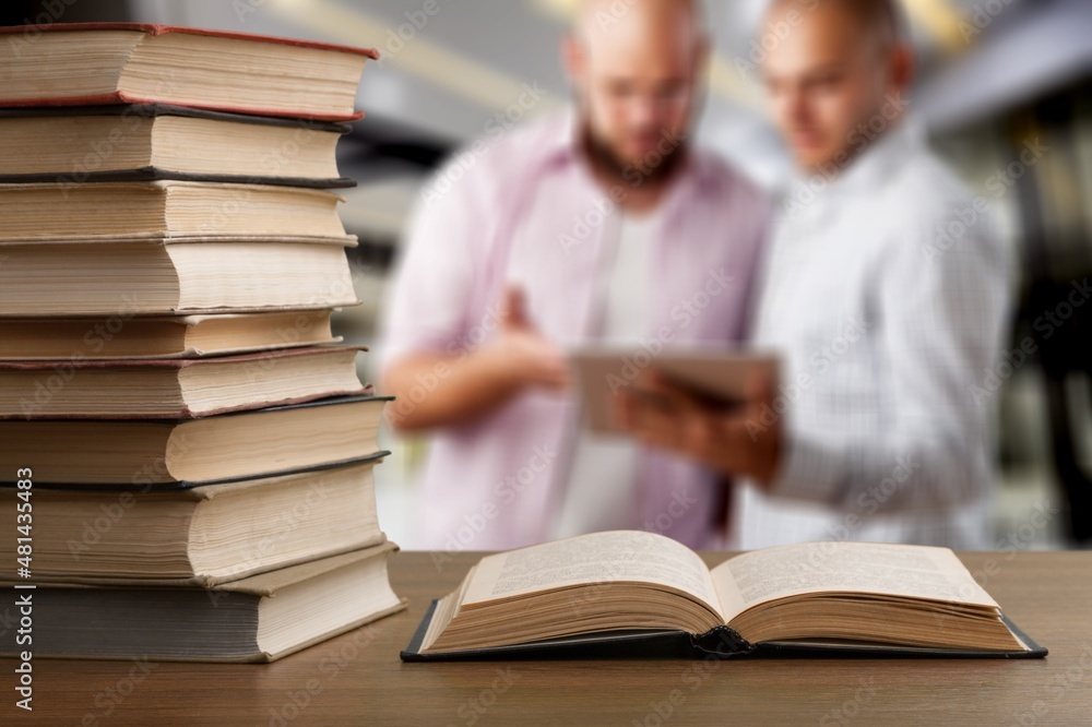 Hardcover law books stacked on wooden table on blur room background, Law Office, pile of books