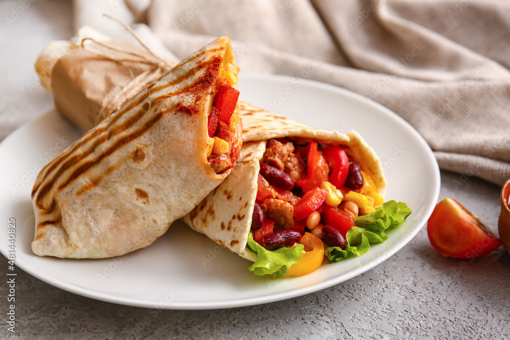 Plate with delicious burritos on grey background, closeup