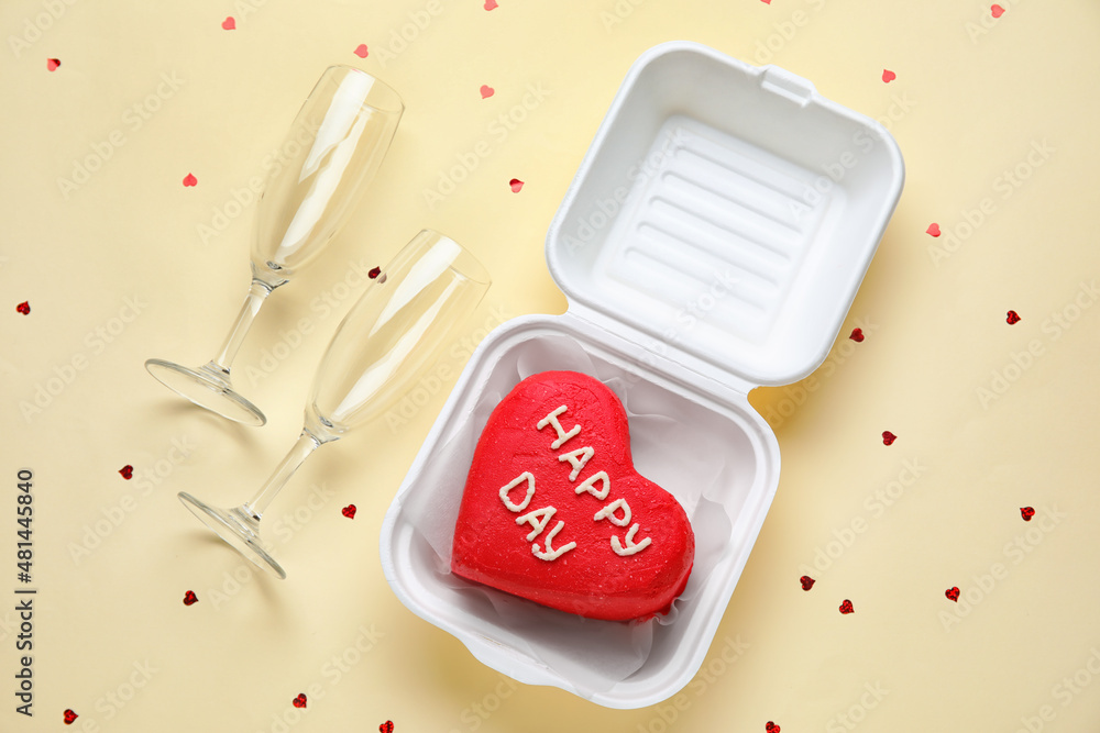 Plastic lunch box with tasty bento cake and glasses on beige background