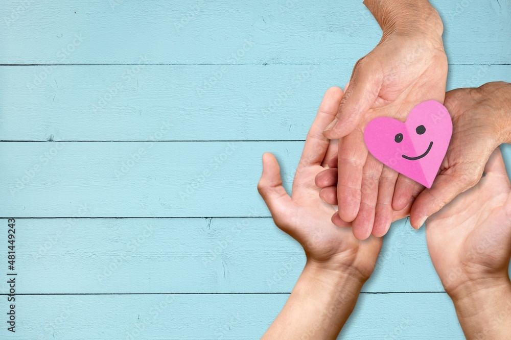 Couple hands holding paper cut heart, family insurance, world heart day, health care, love,