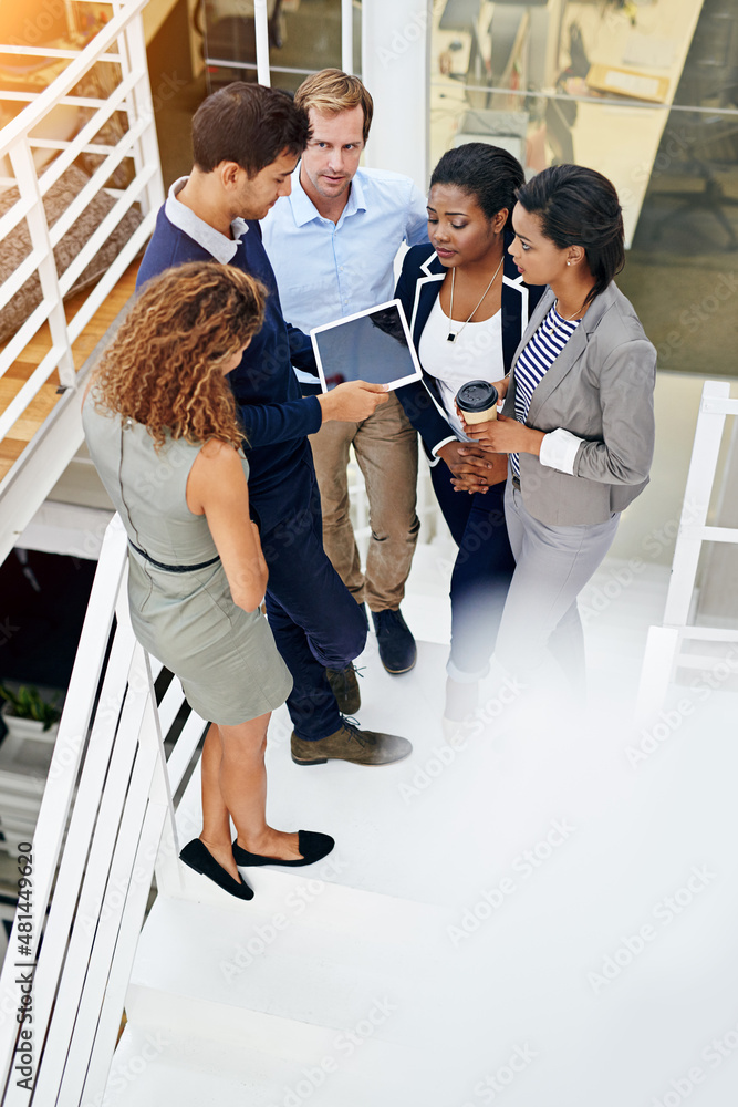 Everyone is in on this project. Shot of a group of coworkers having a meeting in a stairwell in a mo