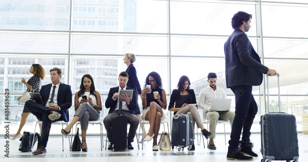 Theyre all ready to board. Full length shot of a young businessman walking through an airport with 