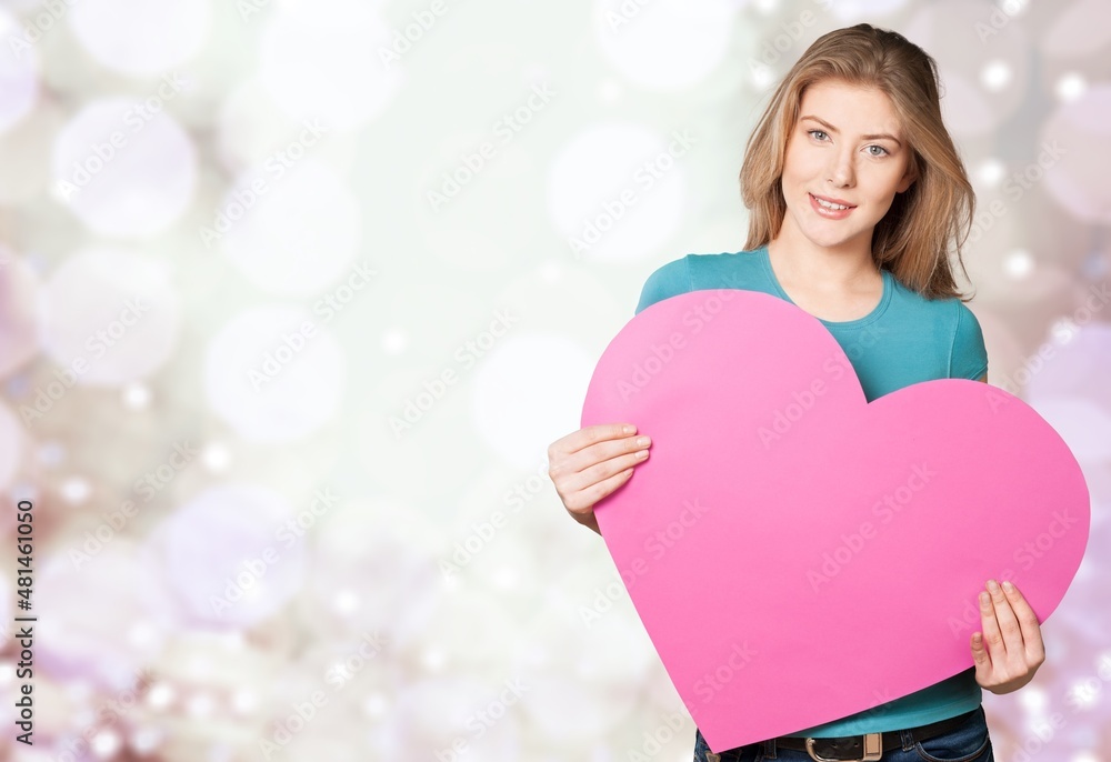 portrait of attractive happy smiling girl with heart, love holiday valentine symbol