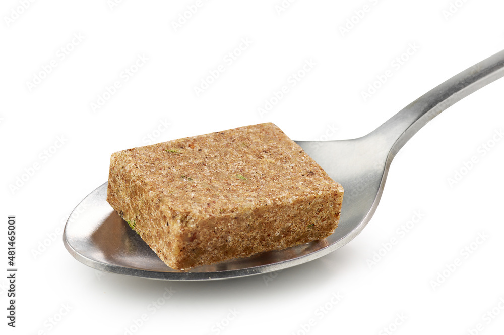 instant beef broth cube in a spoon