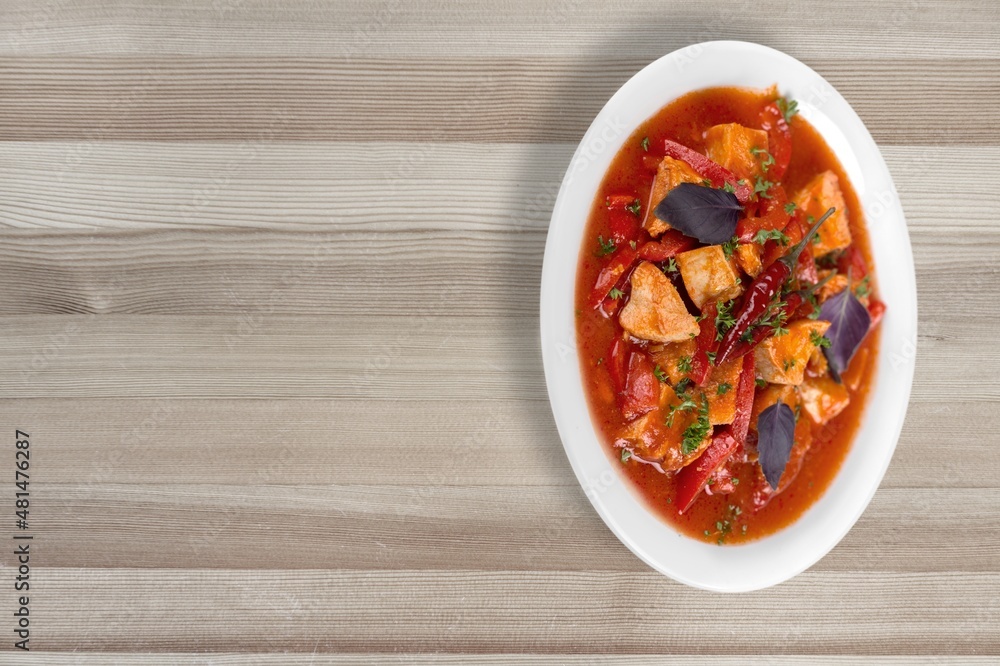 Thai dish with chicken, eggs, spicy, curry paste, tomatoes in a bowl