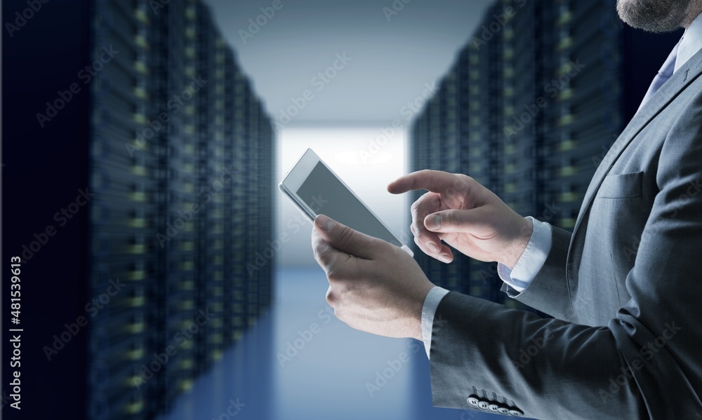 Portrait of Smiling IT Specialist Using Tablet Computer in Data Center room