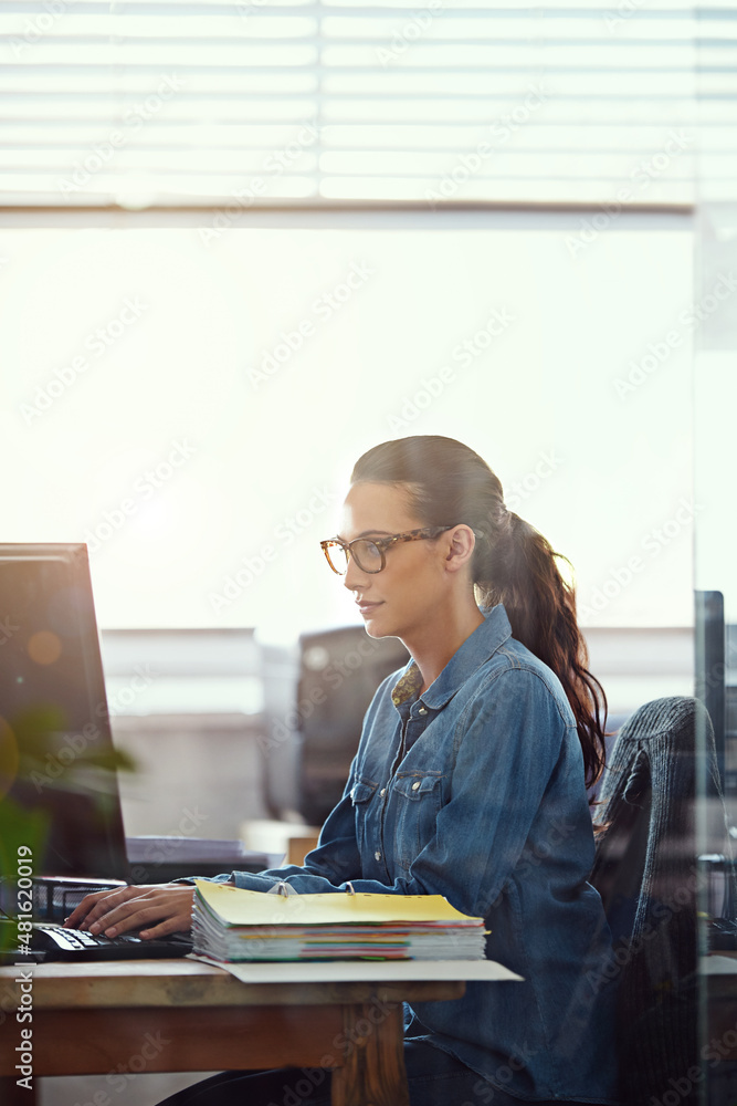 Working hard to meet her deadlines. Cropped shot of a businesswoman working at her desk.