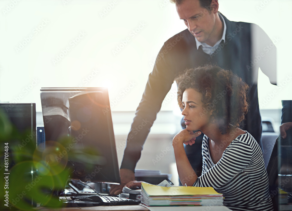 She needed a second opinion. Cropped shot of two colleagues working together in the office.