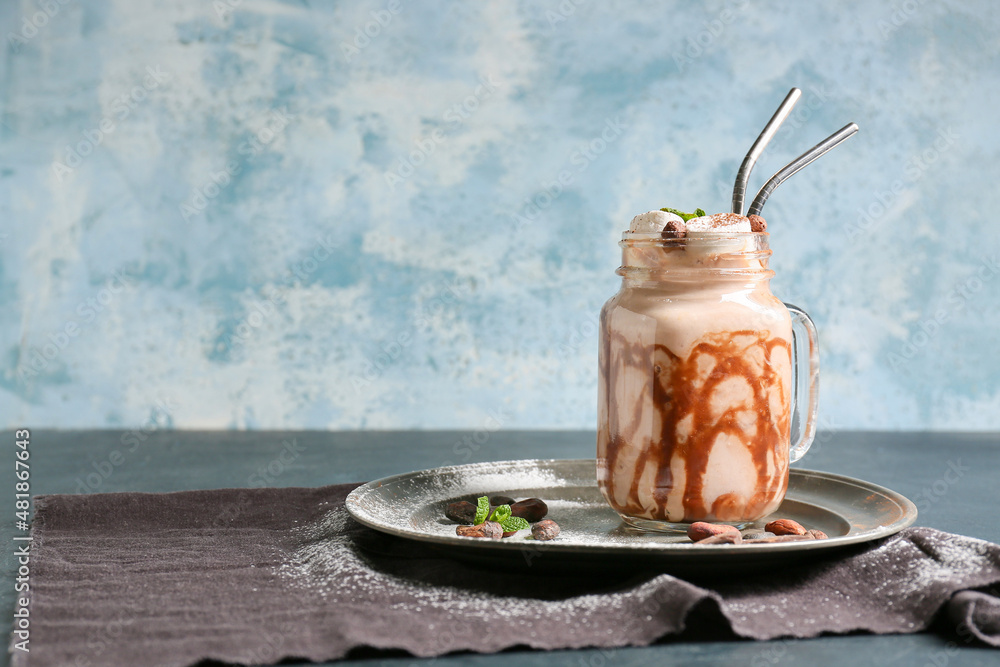 Mason jar of sweet cocoa drink on table