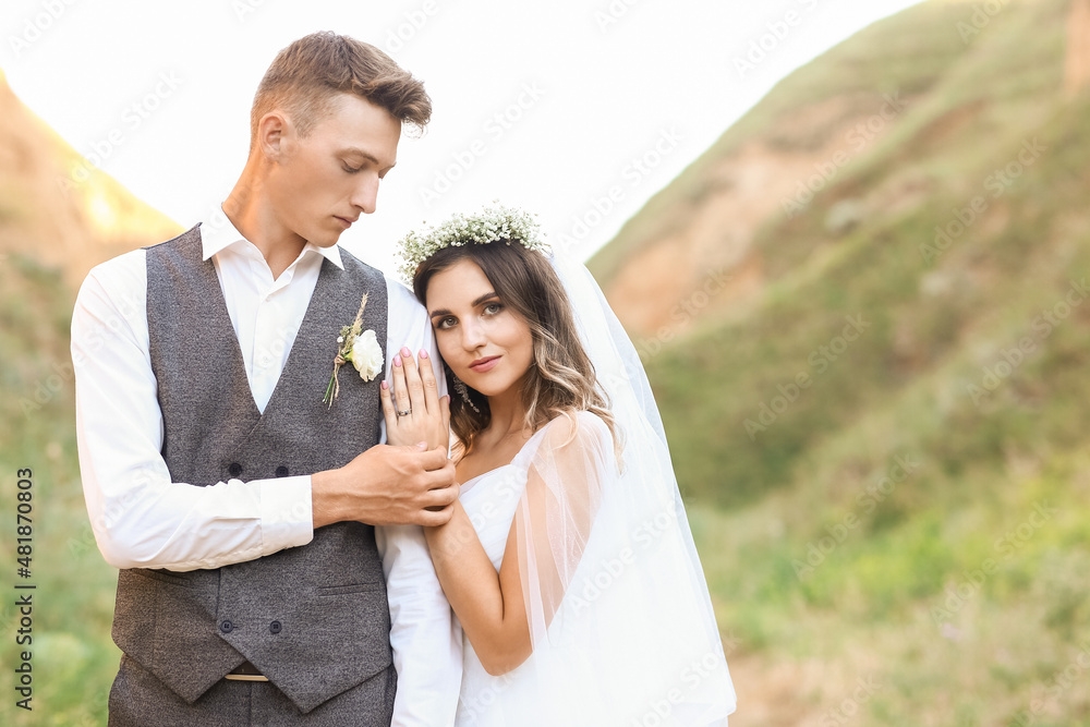 Happy wedding couple in countryside