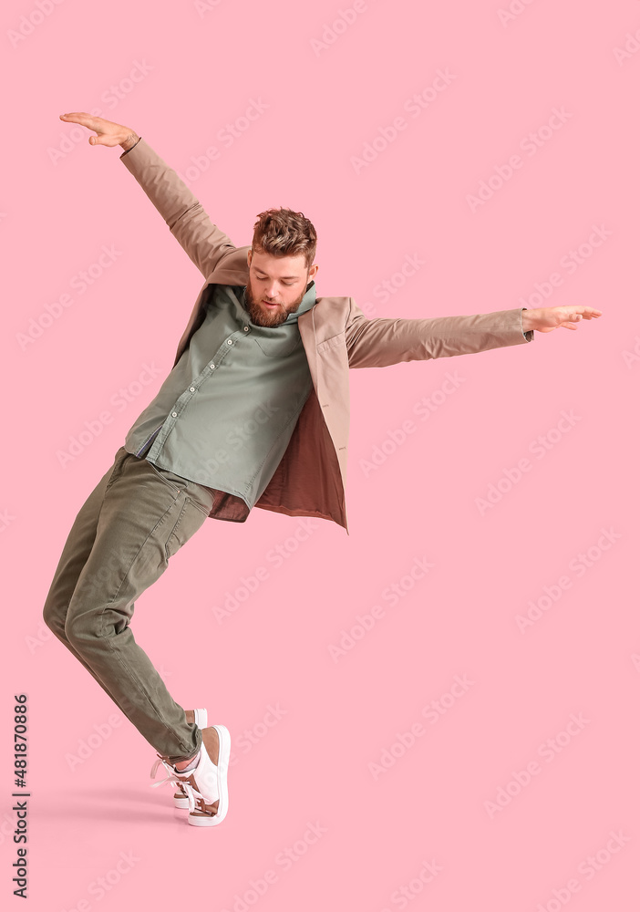 Cool dancing young man on color background