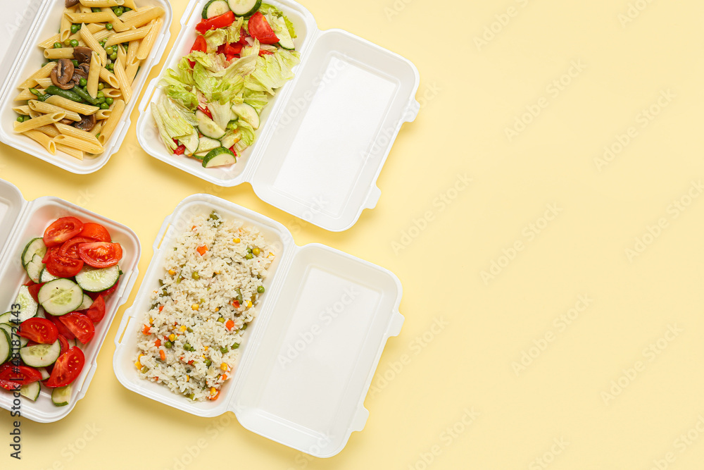 Food delivery containers with different meals on color background