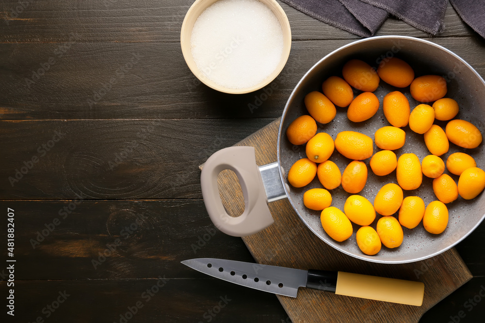 Preparing of tasty kumquat jam on table