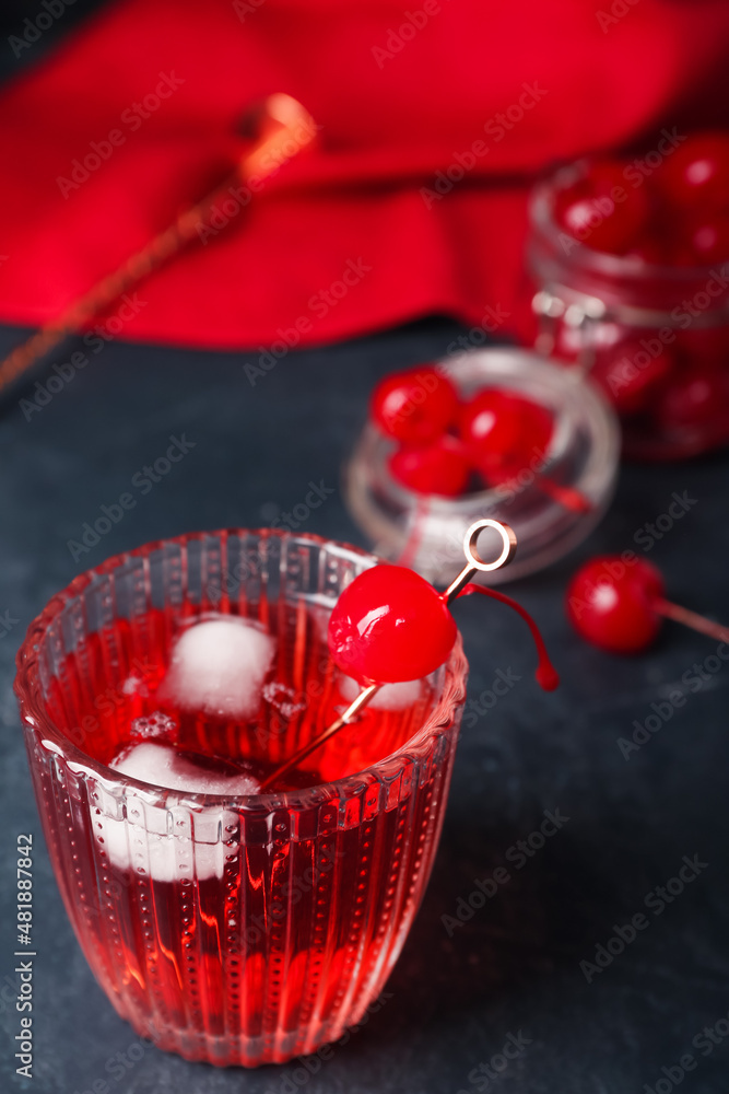 Glass of tasty Manhattan cocktail on black background