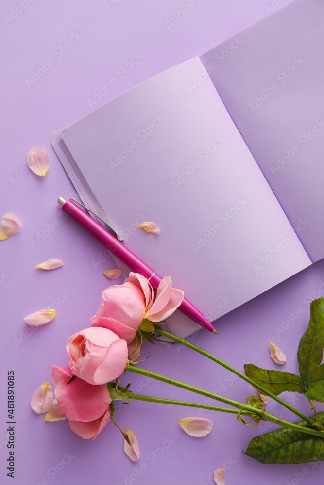 Composition with blank open notebook, pen and rose flowers on lilac background