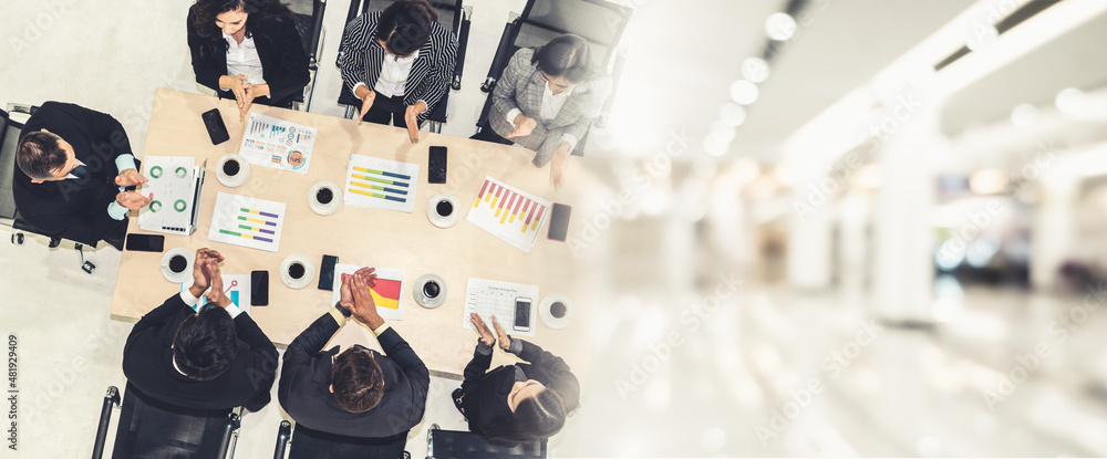 Successful business people celebrate together with joy at office table shot from top view . Young bu