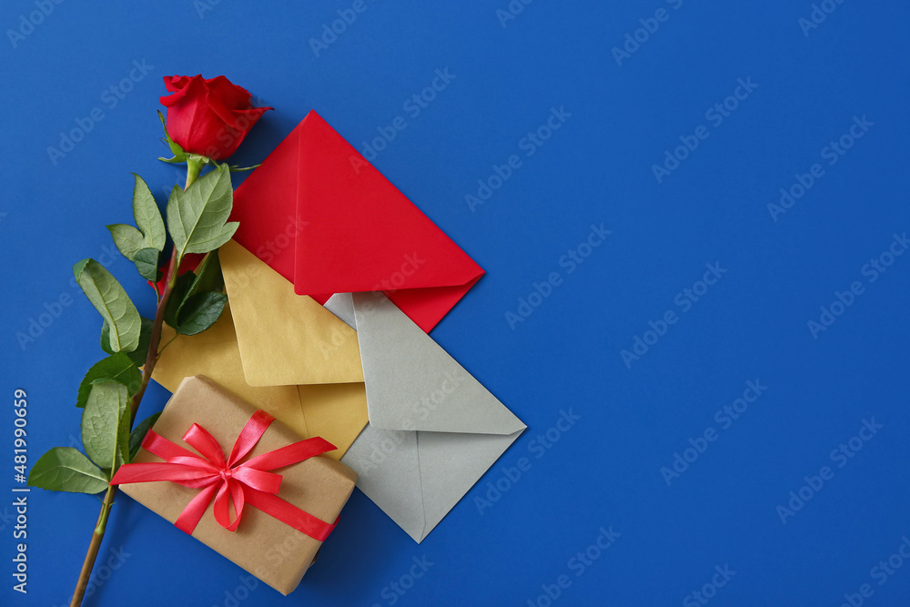 Valentines Day gift, rose and envelopes on color background