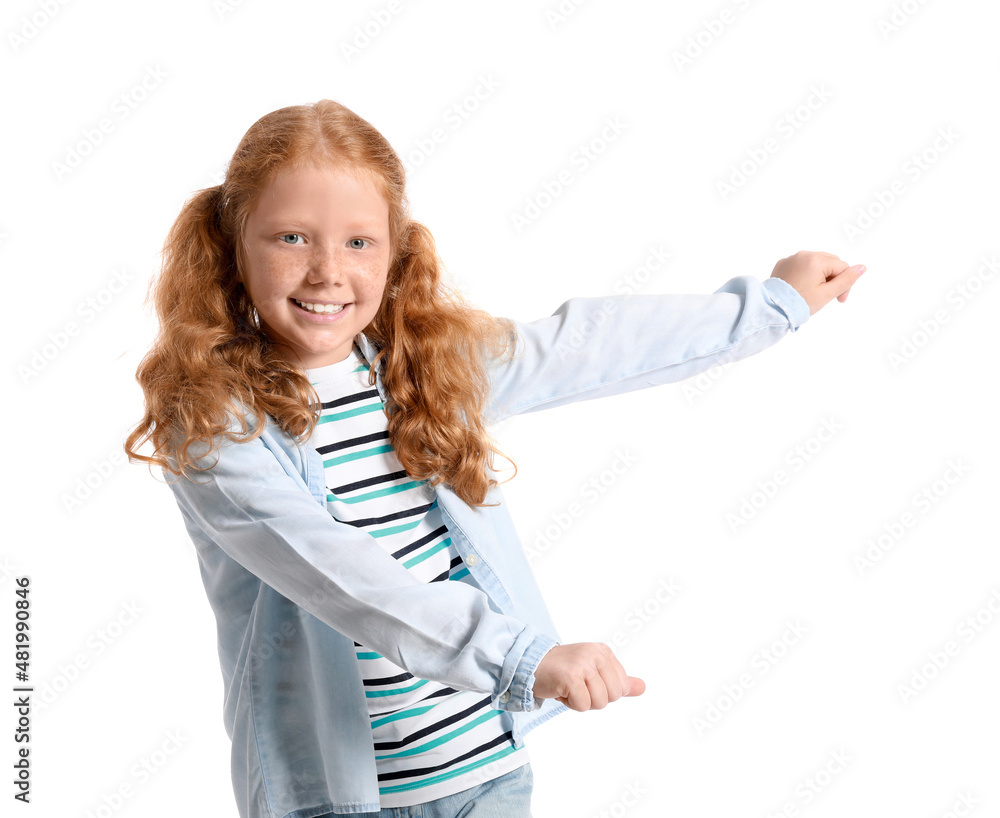 Little redhead girl with ponytails dancing on white background