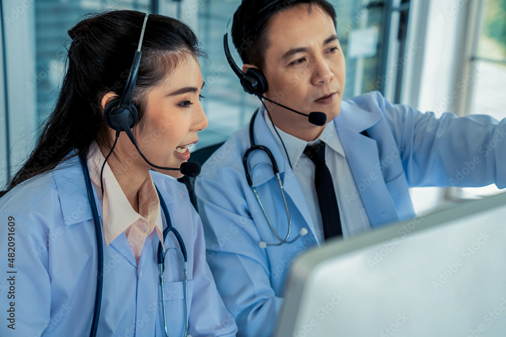 Doctor team wearing headset talking actively on video call in hospital clinic . Concept of telehealt