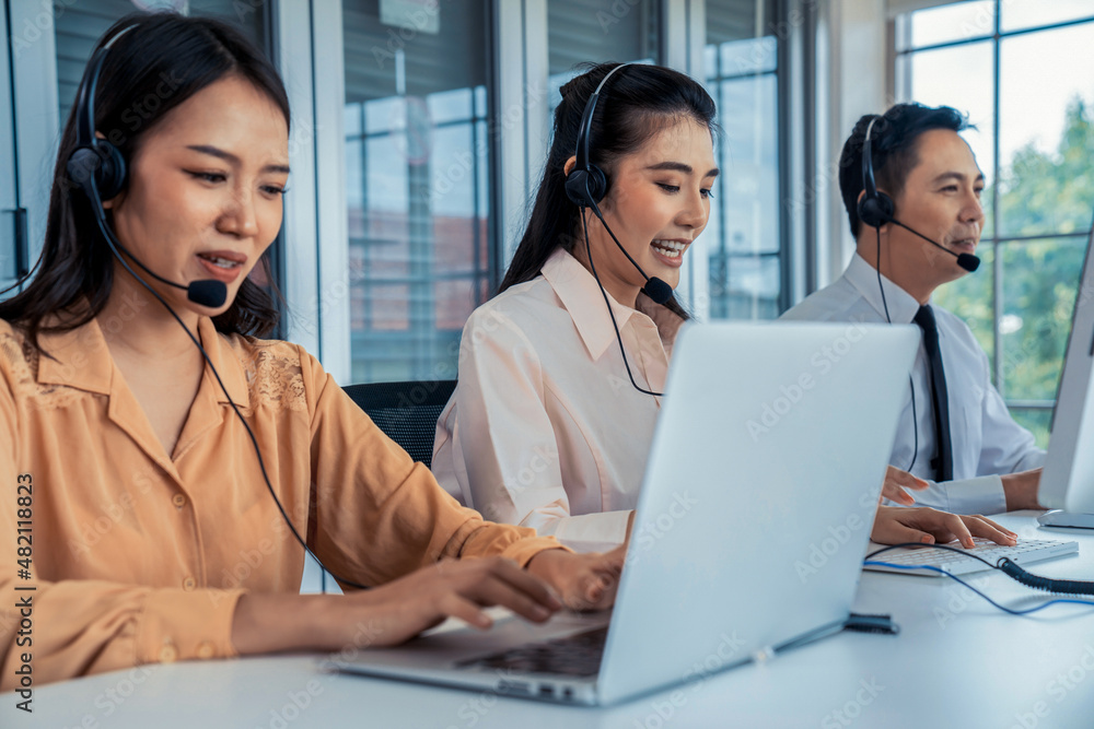 Business people wearing headset working actively in office . Call center, telemarketing, customer su