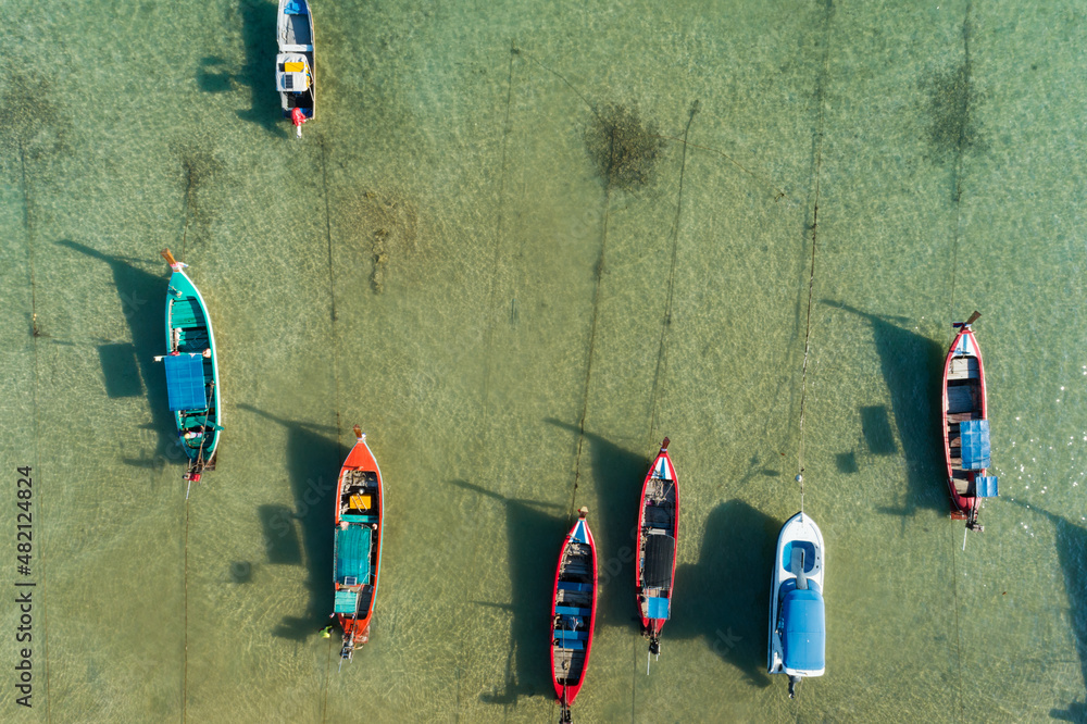 Aerial drone birds eye view photo Top down of tropical sea with long tail fishing boats Travel boat