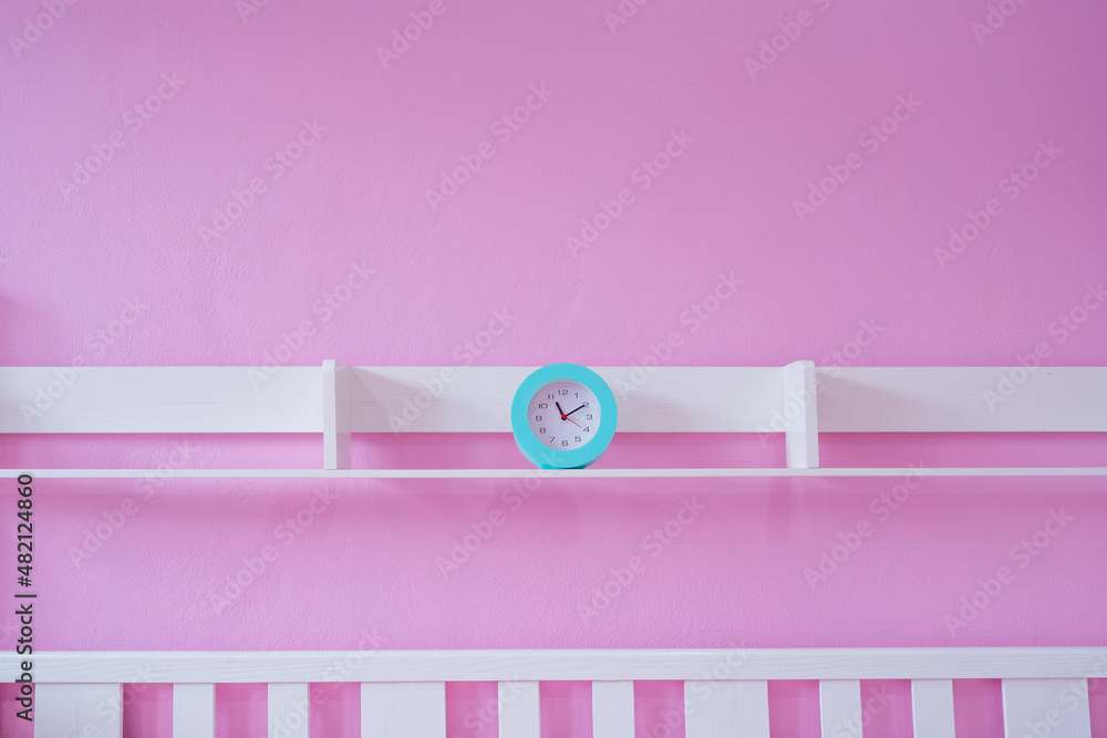 Beautiful alarm clock on colorful wall background