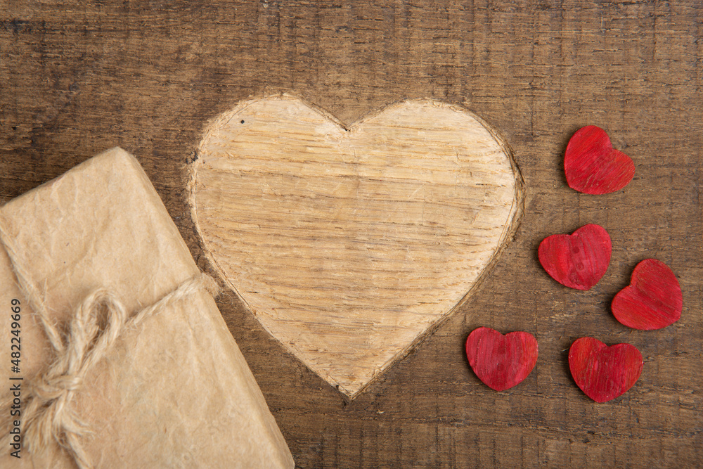 Valentines Day greetings concept. Gift boxes and Heart shape carved on the wood. Valentines greetin