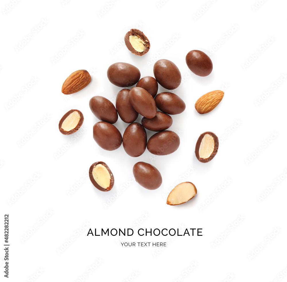 Creative layout made of almonds in chocolate on the white background. Flat lay. Food concept.