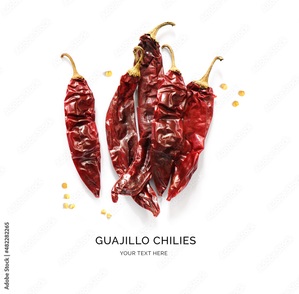 Creative layout made of guajillo chilies on the white background. Flat lay. Food concept.