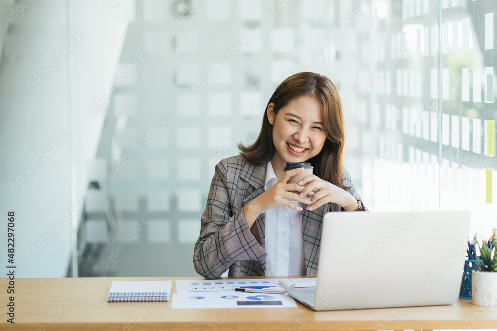 Asian woman working on a laptop computer,Working in the office with laptop concept,Young Asian woman