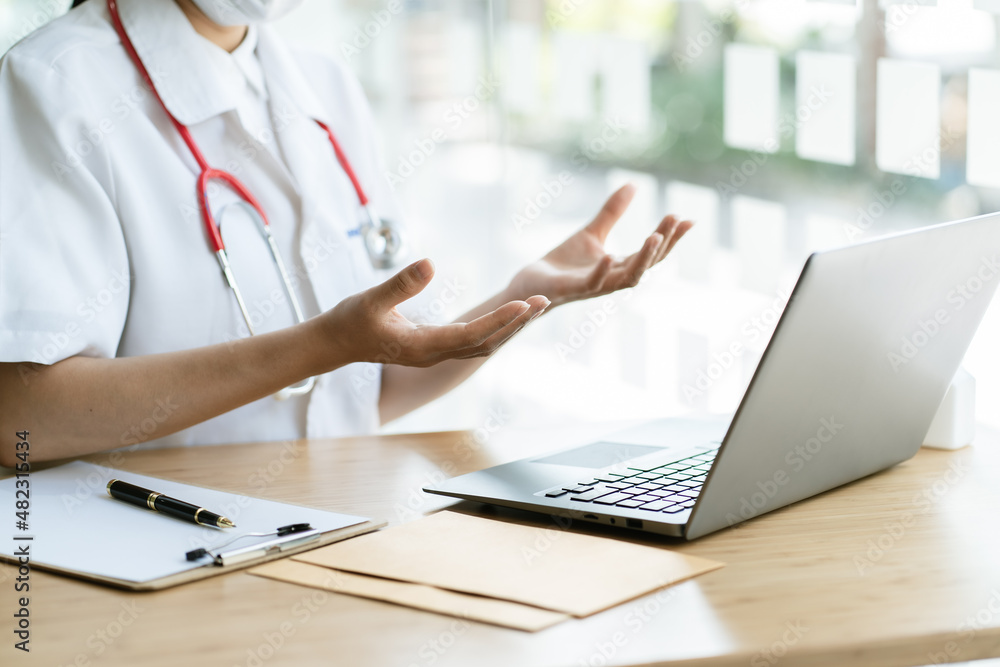 Asian female doctor using laptop computer online video call remote talking to patient, prescribe med