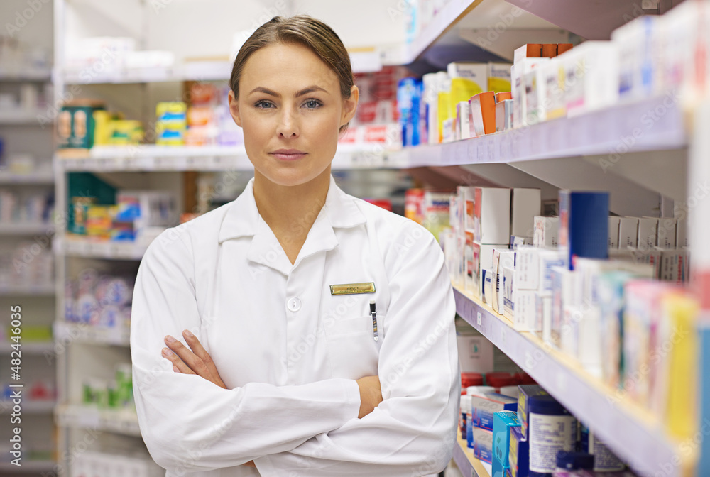 Youre in capable hands. Portrait of an attractive young pharmacist standing in an aisle.