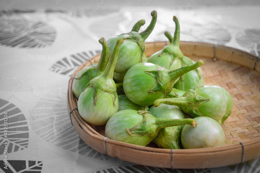 Close-up of Fresh Round Thai Eggplant on bamboo baskets.