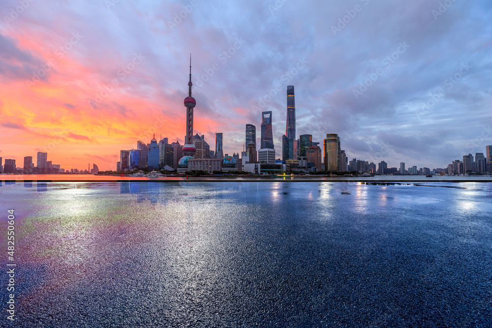 Empty asphalt road and city skyline with modern commercial buildings in Shanghai, China.