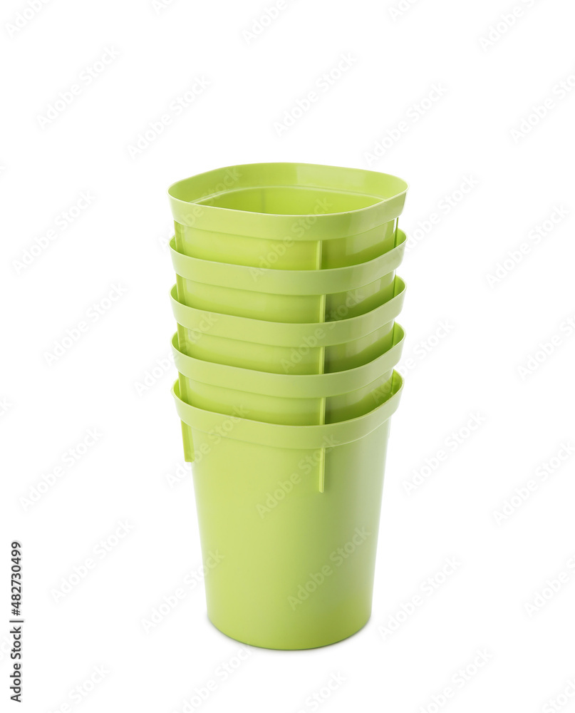 Stack of green flower pots on white background