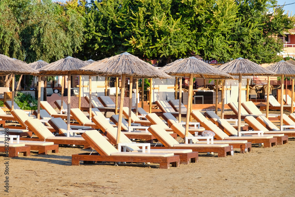 Sun loungers and beach umbrellas at sea resort