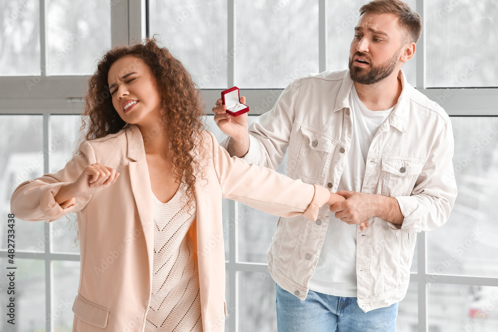 Young woman rejecting marriage proposal at home