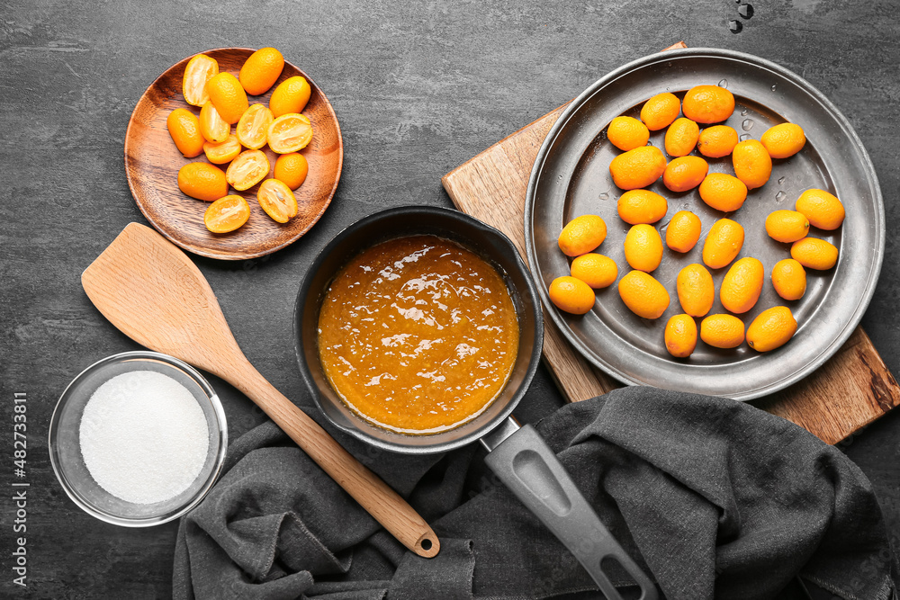 Preparing of tasty kumquat jam on table