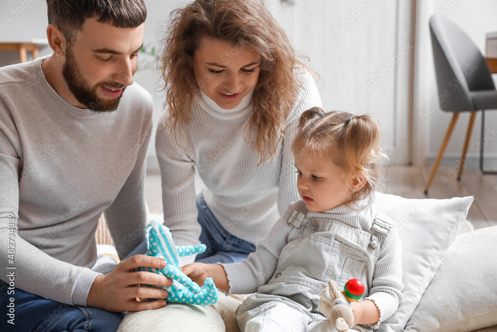 Happy young family spending time together at home