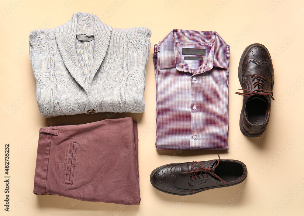 Stylish male clothes and shoes on color background