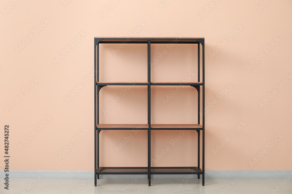 Empty modern shelf unit near color wall in room