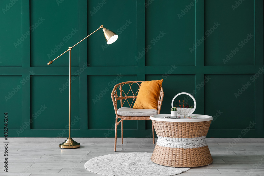 Interior of room with wicker chair, floor lamp and table