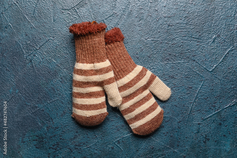 Warm mittens on dark color background